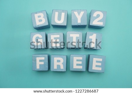 Buy 2 Get 1 Free created with cubes on blue background