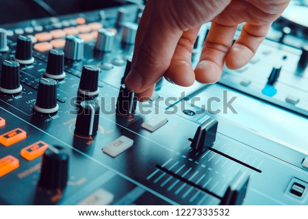 image of Dj playing music at mixer closeup