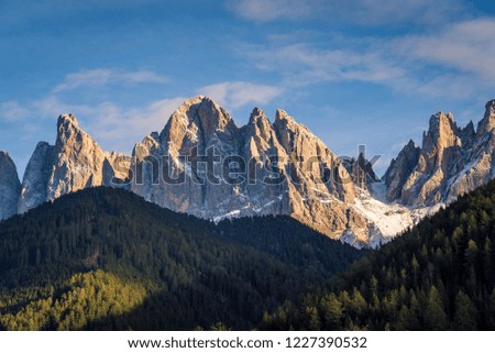 Afternoon sunlight on The Dolomites Geisler Odle mountain peaks in the Vilnoss Valley in Val di Funes in South Tyrol, Northern Italy.