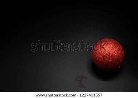 Christmas wallpaper background of red celebration tree ball isolated on black background.