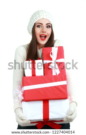 Happy woman wearing Santa hat holding gift box. Close up portrait with shoulders.