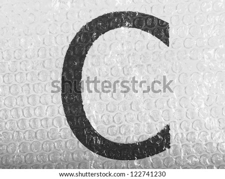 C   letter  painted on bubblewrap
