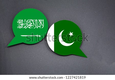 Saudi Arabia and Pakistan flags with two speech bubbles on dark gray background