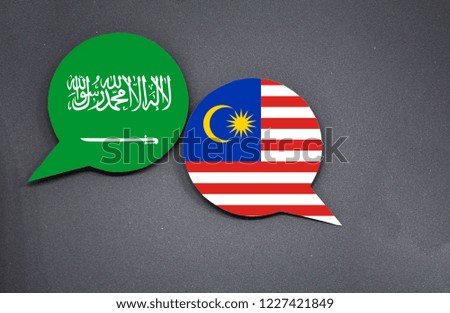 Saudi Arabia and Malaysia flags with two speech bubbles on dark gray background