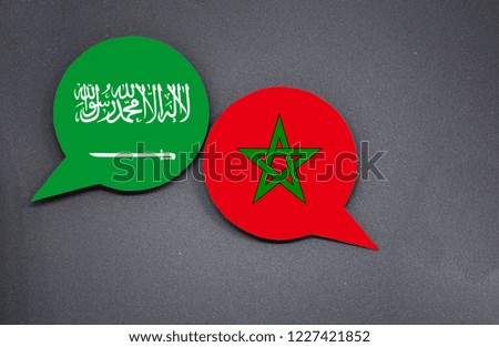 Saudi Arabia and Morocco flags with two speech bubbles on dark gray background