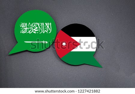 Saudi Arabia and Jordan flags with two speech bubbles on dark gray background