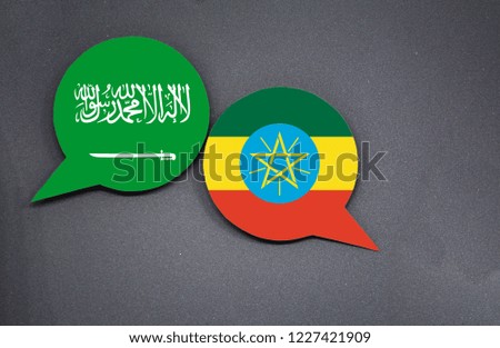 Saudi Arabia and Ethiopia flags with two speech bubbles on dark gray background