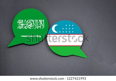 Saudi Arabia and Uzbekistan flags with two speech bubbles on dark gray background