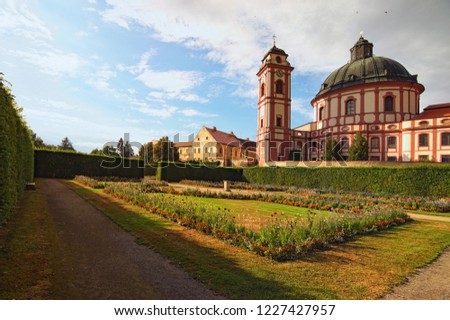Classic wide-angle view of amazing cathedral and scenic garden in famous baroque palace Jaromerice nad Rokytnou. South Moravia, Czech Republic, Central Europe.