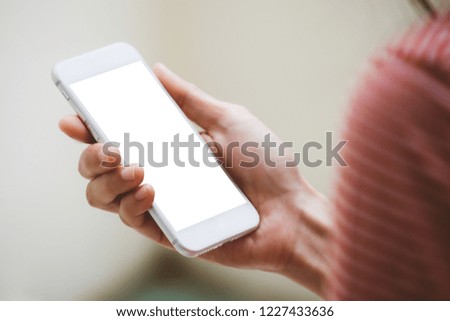 mockup image.woman hand holding texting white cell phone at workplace with concept for electric,communication device research world international modern business,techonology