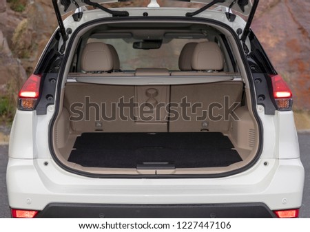 Rear view of a SUV car with open trunk Royalty-Free Stock Photo #1227447106