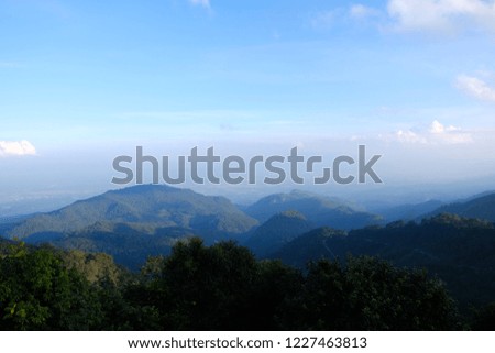 Mountain, wood and blue sky background