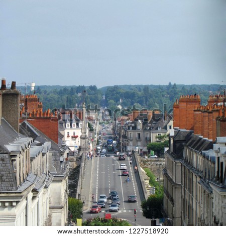 The city Blois in France with the views on buildings, and street lot of cars                 