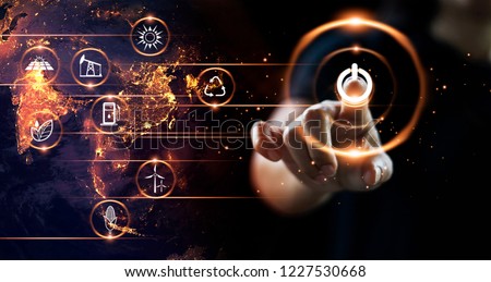 Finger pressing power button with energy resources icon on earth at night background. Earth day. Environment and conservation. Energy saving concept. Royalty-Free Stock Photo #1227530668