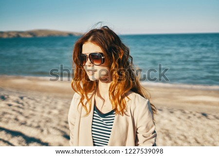 pretty woman in glasses and the sea in the background                      