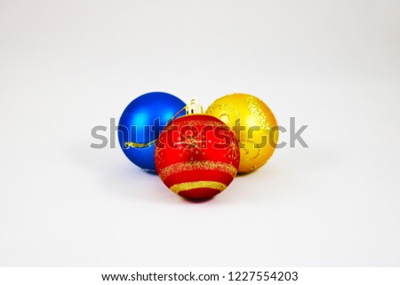 Three colorful christmas balls isolated on a white background