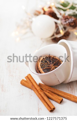 cup with spices on white background
