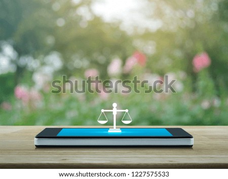 Law flat icon on modern smart mobile phone screen on wooden table over blur pink flower and tree, Business legal service online concept