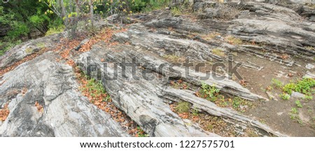 Nature landscape view of old stone. Balanced Brown color. The natural structure of a layered rock for design Background. Close up of crushed grey and brown stone on ground or wall texture background.