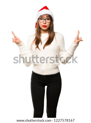 Girl with celebrating the christmas holidays with fingers crossing and wishing the best on isolated white background