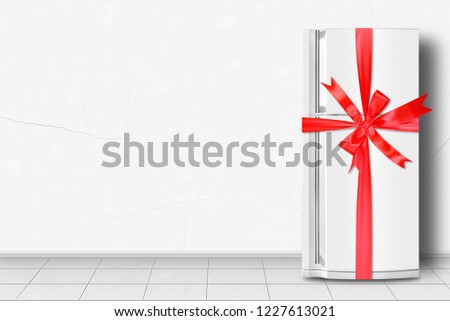 Major appliance - Refrigerator gift tied red bow in front on a white wall background Royalty-Free Stock Photo #1227613021
