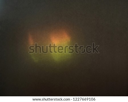 Color blurred defocused noisy bright reflected light. The glare, the spectrum, sunlight spot on a dark background