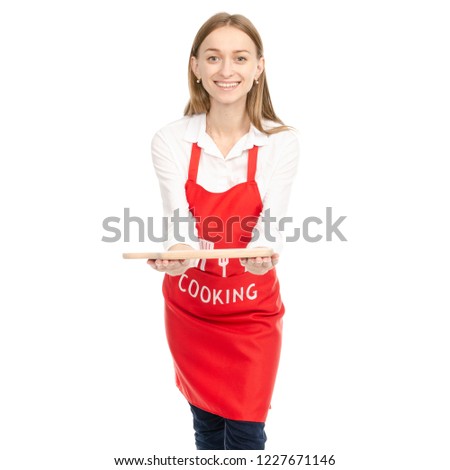 A woman in a red apron in the hands wooden cutting board on a white background. Isolation