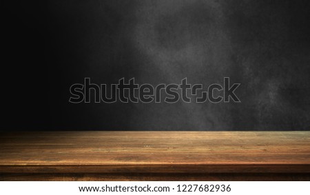 Wood table on dark background.