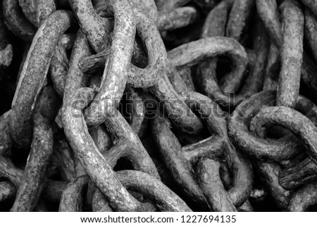 Chain from the anchor of a fishing boat, chain links in black and white