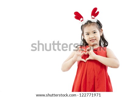 Portrait of happy little girl in Santa dress playing