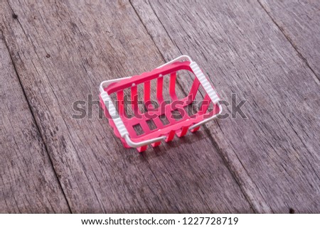 empty shopping basket on wooden background. business concept. 