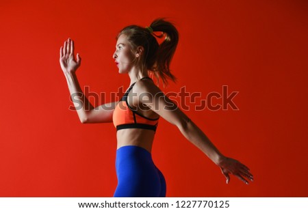 Woman runner in silhouette on red background. Dynamic movement. Side view
