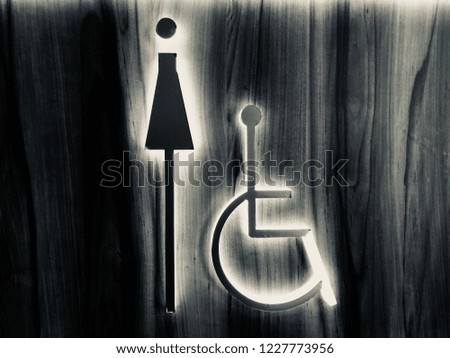Woman Pushing A Handicapped Symbol