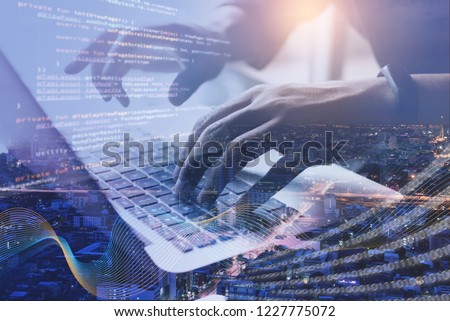 Digital technology, software development, IoT concept. Double exposure, man programmer, software developer managing project on laptop computer and smart city with binary, big data and computer code