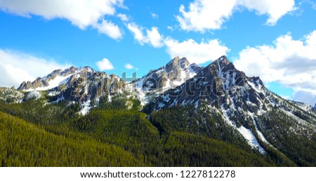 Sawtooth Mountains, Idaho, USA - Horizontal Aerial View Of Jagged Snowy Peaks With Pine Trees On The Slopes