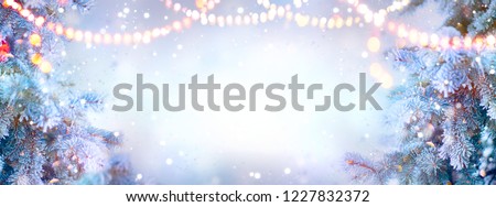 Christmas background. Xmas tree with snow decorated with garland lights, holiday festive background. Widescreen frame backdrop. New year Winter art design, Christmas scene