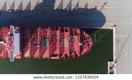 Aerial top down photo of empty container ship bow is cargo vessel that carries all of load in truck-size containers in technique called containerization and carry most seagoing non-bulk freight Royalty-Free Stock Photo #1227838504