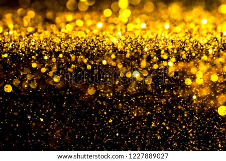 Explosive blur gold powder light christmas and  happy new year. 
Defocused golden dust sparkle glitter silver white for texture background.