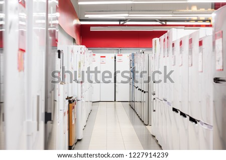 Rows of white and silver fridges in appliance store's showroom Royalty-Free Stock Photo #1227914239