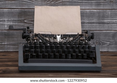 image of retro typewriter on wooden background. writer, journalist.