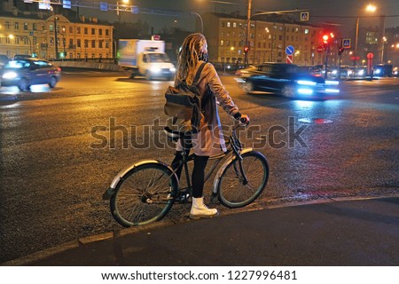 young cyclist stopping at a red light at a crossroads          