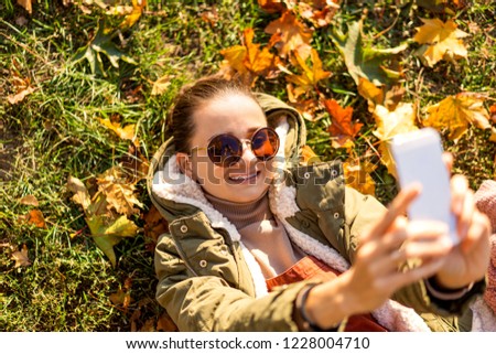 girl in the park in nature makes selfie