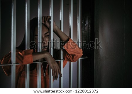 Portrait of woman desperate to catch the iron prison,prisoner concept,thailand people,Hope to be free.