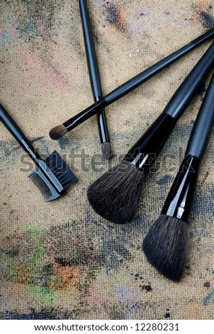 Close-up photo of five brushes on a dingy background