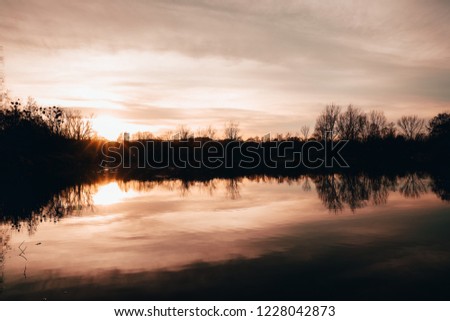 Twilight fog on the lake during sunset with reflection on the wa