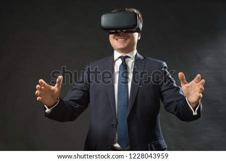 360. Virtual game. Man in black suit uses a virtual reality glasses.  VR