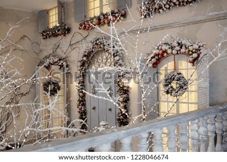 Beautiful house in a snowy yard decorated for Christmas and New Year