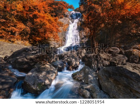 Beautiful waterfall in spring forest with sunlight. Traveling in the spring forest and new discovery waterfalls. 