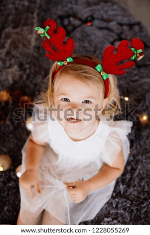Baby girl with deer horns.