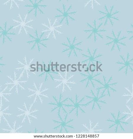 Winter seamless pattern with chaotic snowflakes in different shades of blue color. Light Christmas repeat backdrop using for cards, wallpapers, scrapbooking, print, gift wrap, UFO camouflage etc.